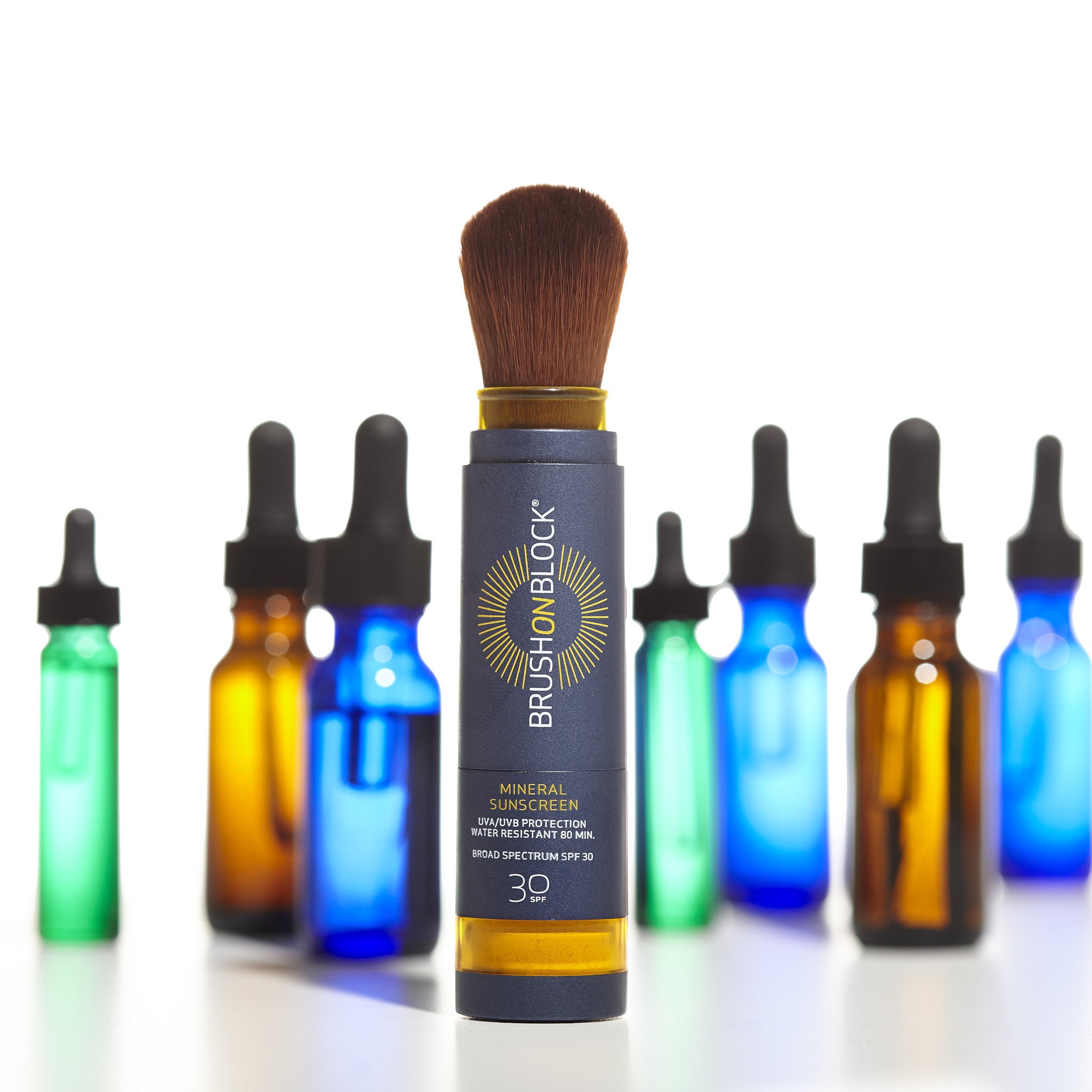 brush on block products in front of eye droppers