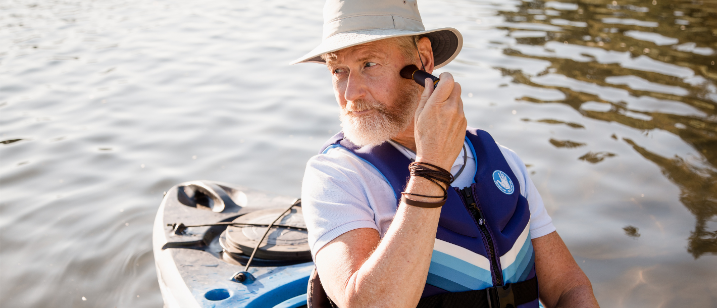 Man in kayak using Brush On Block sunscreen