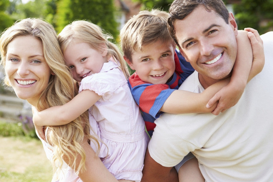 Brush On Block image of family of four enjoying outdoors