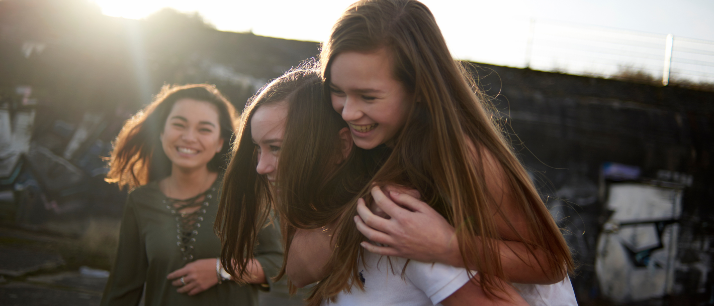 a group of teens smiling together in a group.