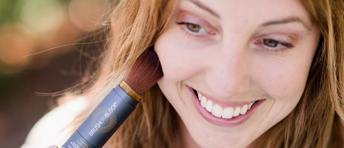 Woman applying Brush On Block outside.