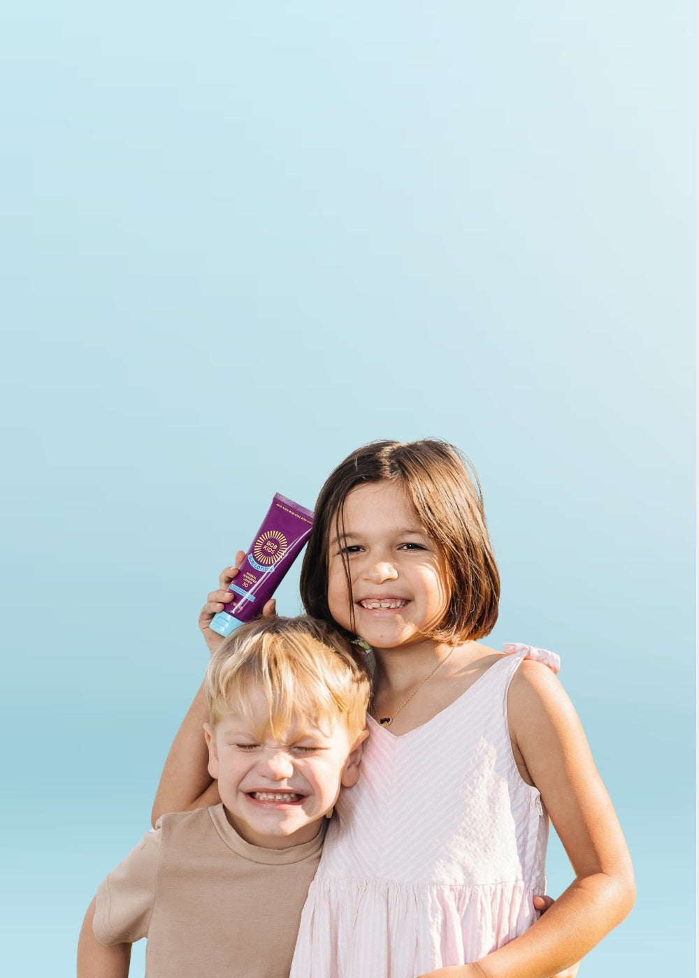 Two kids holding BOB KIDS SPF 30 Sun Lotion