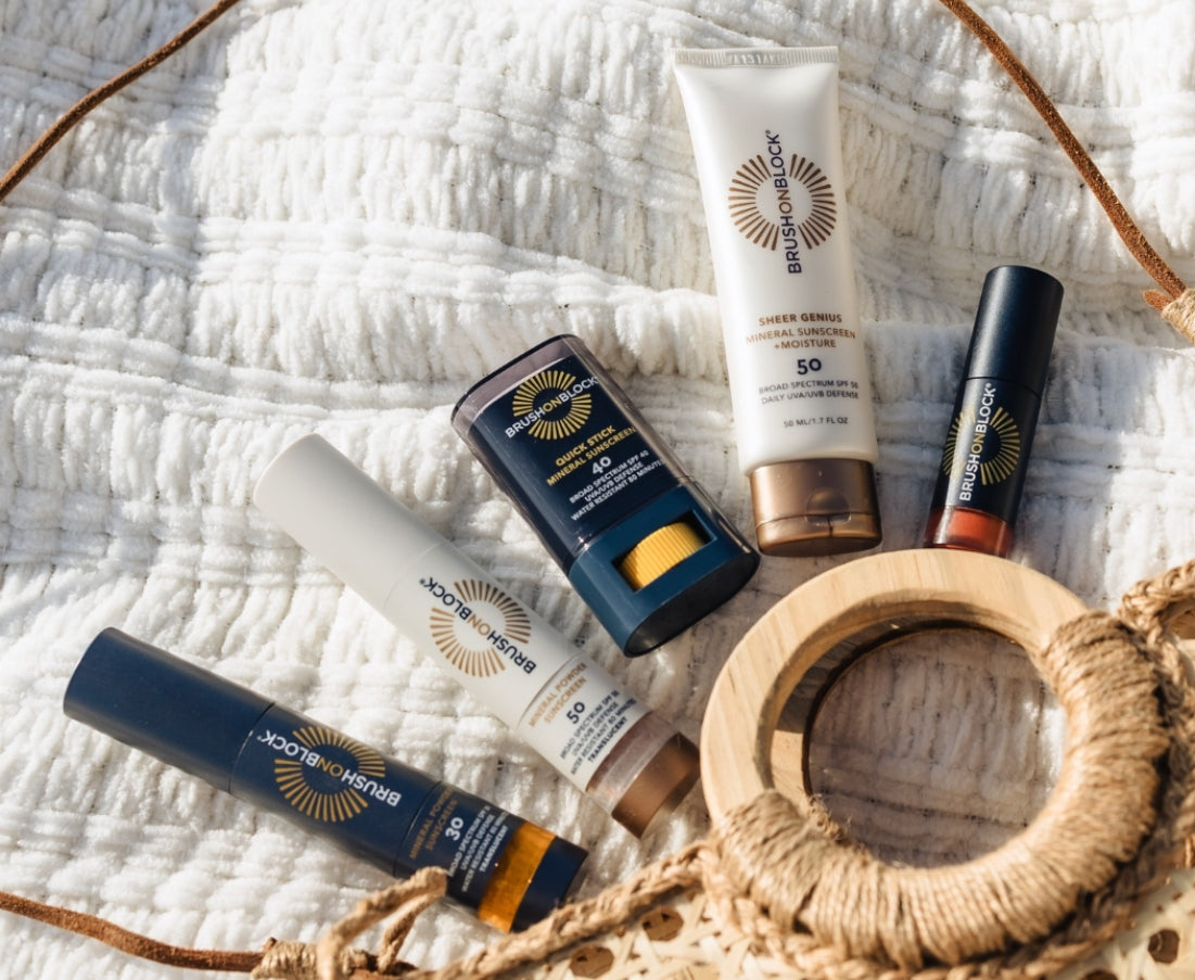 Brush On Block sunscreen products laying outside of a handbag, demonstrating the product line.