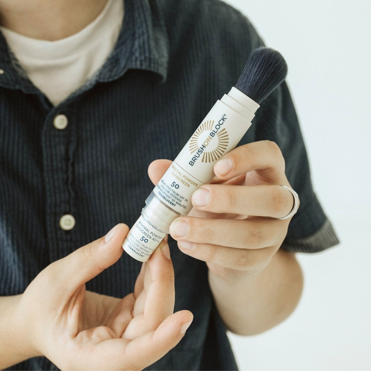 Brush On Block SPF 50 Brush + Refill Set lifestyle shot mineral sunscreen brush applicator