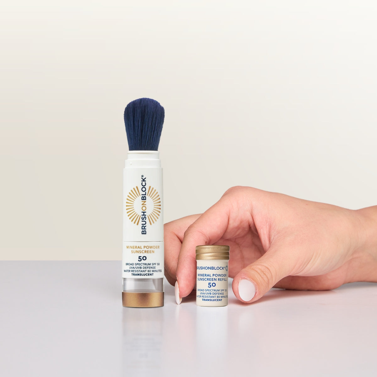 Translucent Mineral Powder Sunscreen Refill SPF 50 lifestyle shot mineral sunscreen brush applicator