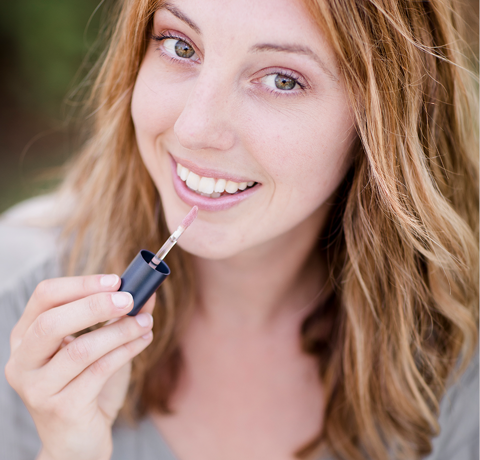 Woman Applying Brush On Block® Mineral Lip Oil with SPF 32