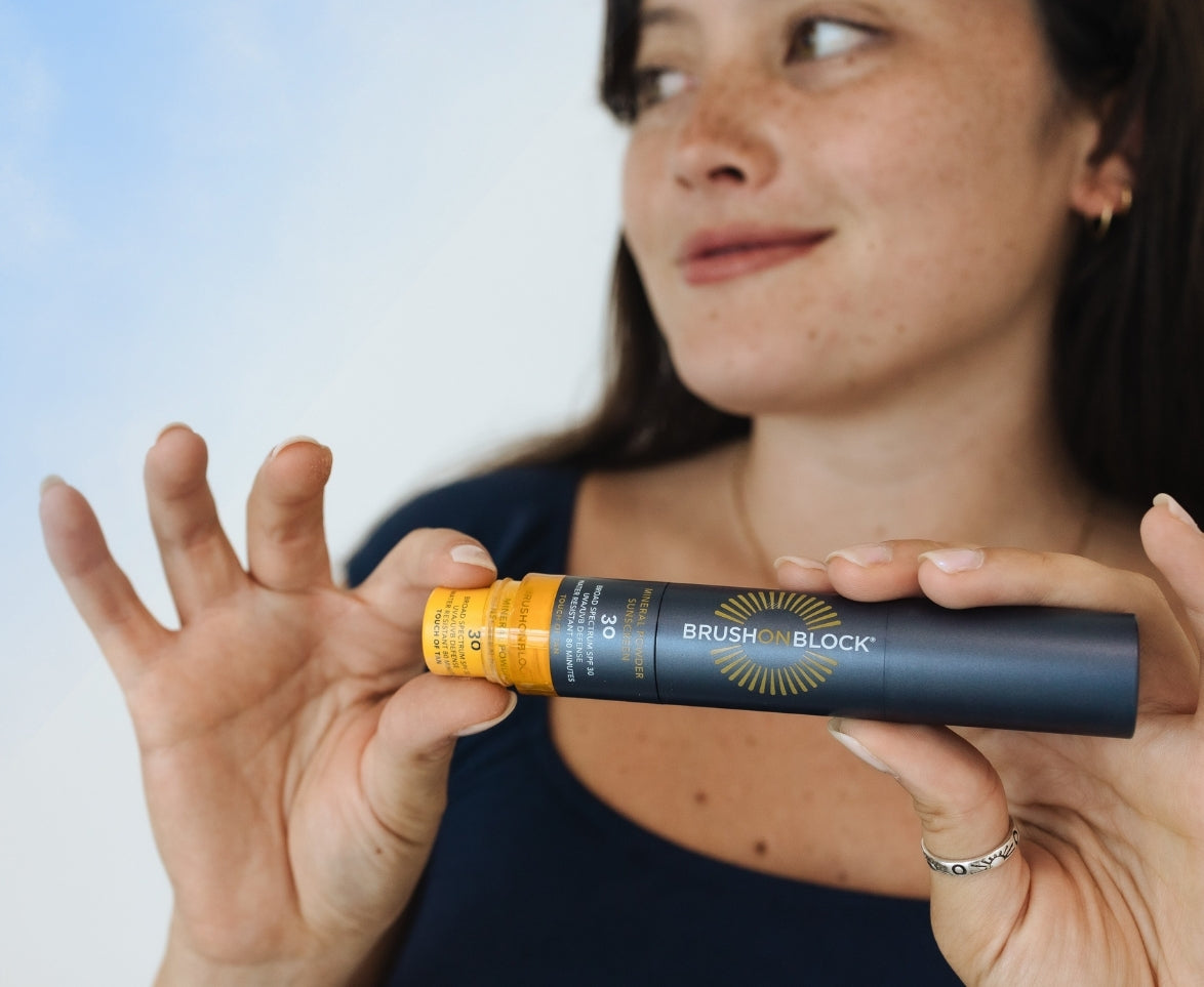 Inserting Brush On Block Touch of Tan SPF 30 Mineral Powder Refill into the Brush