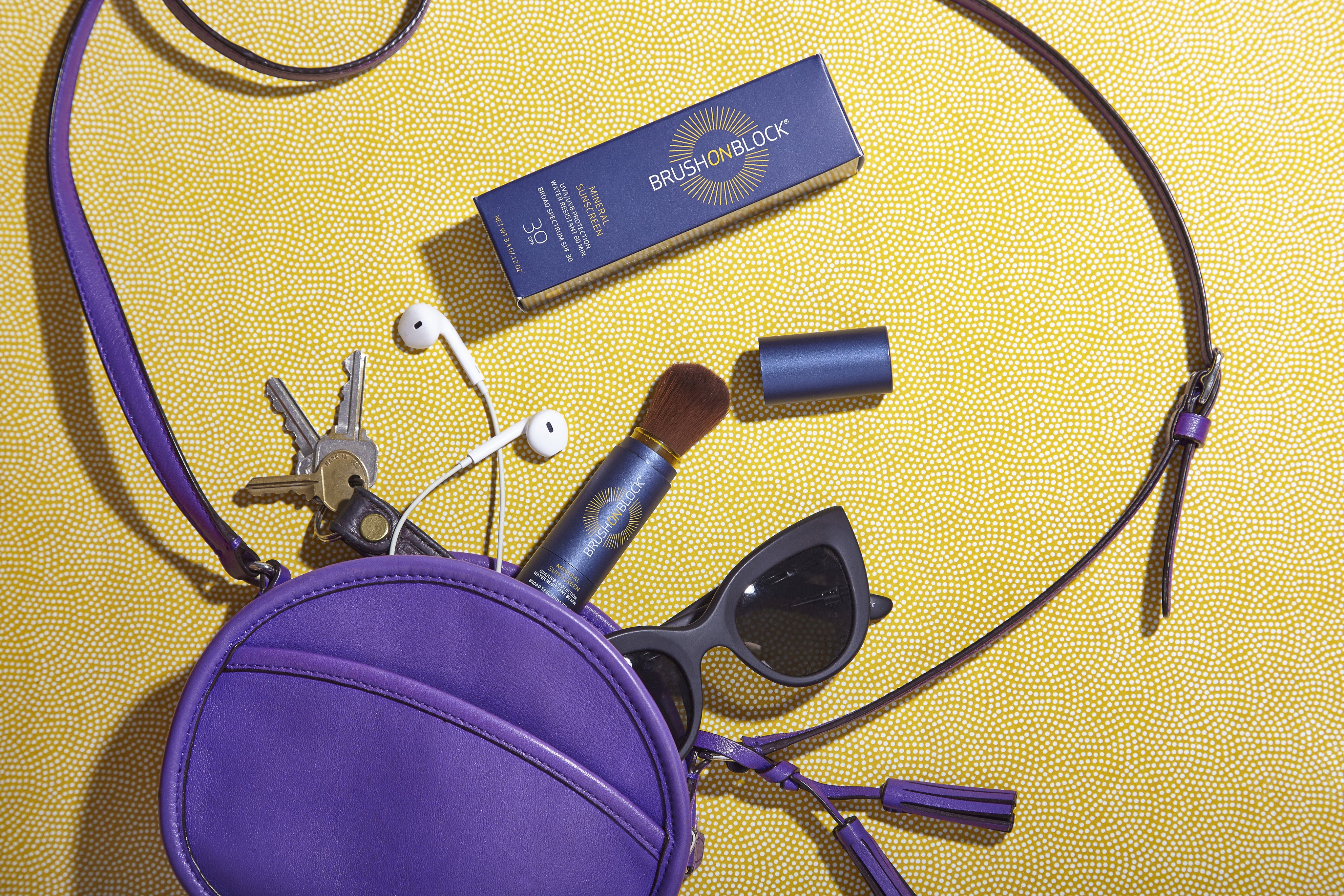 brush on block products spilling out of a purple purse