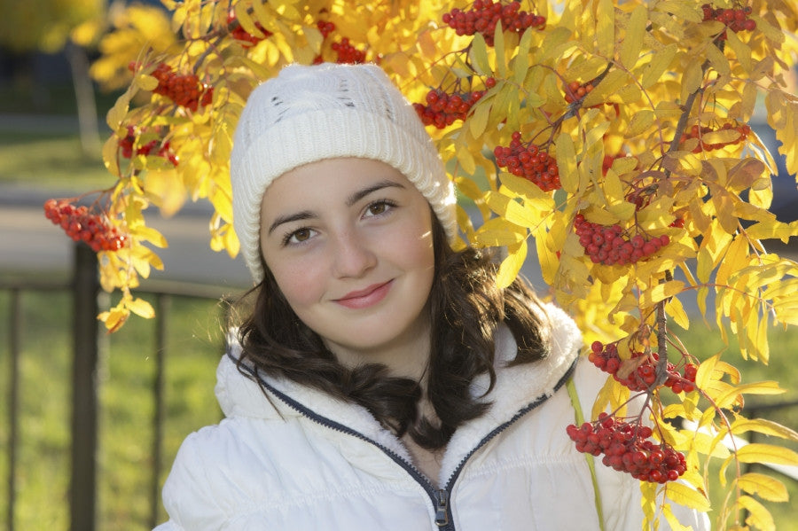 Brush On Block image of girl in hat and coat with fall leaves