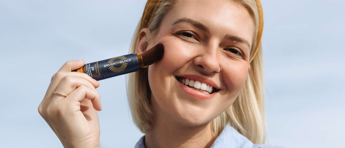 Woman applying Brush On Block mineral powder sunscreen SPF 30 for sensitive skin daily protection 