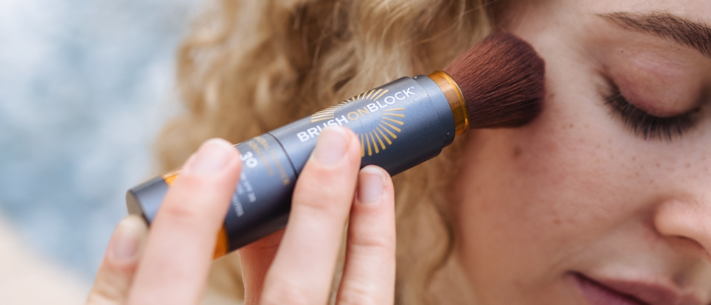 Brush On Block mineral powder sunscreen being buffed onto skin in circular motions, correct application technique for full SPF coverage