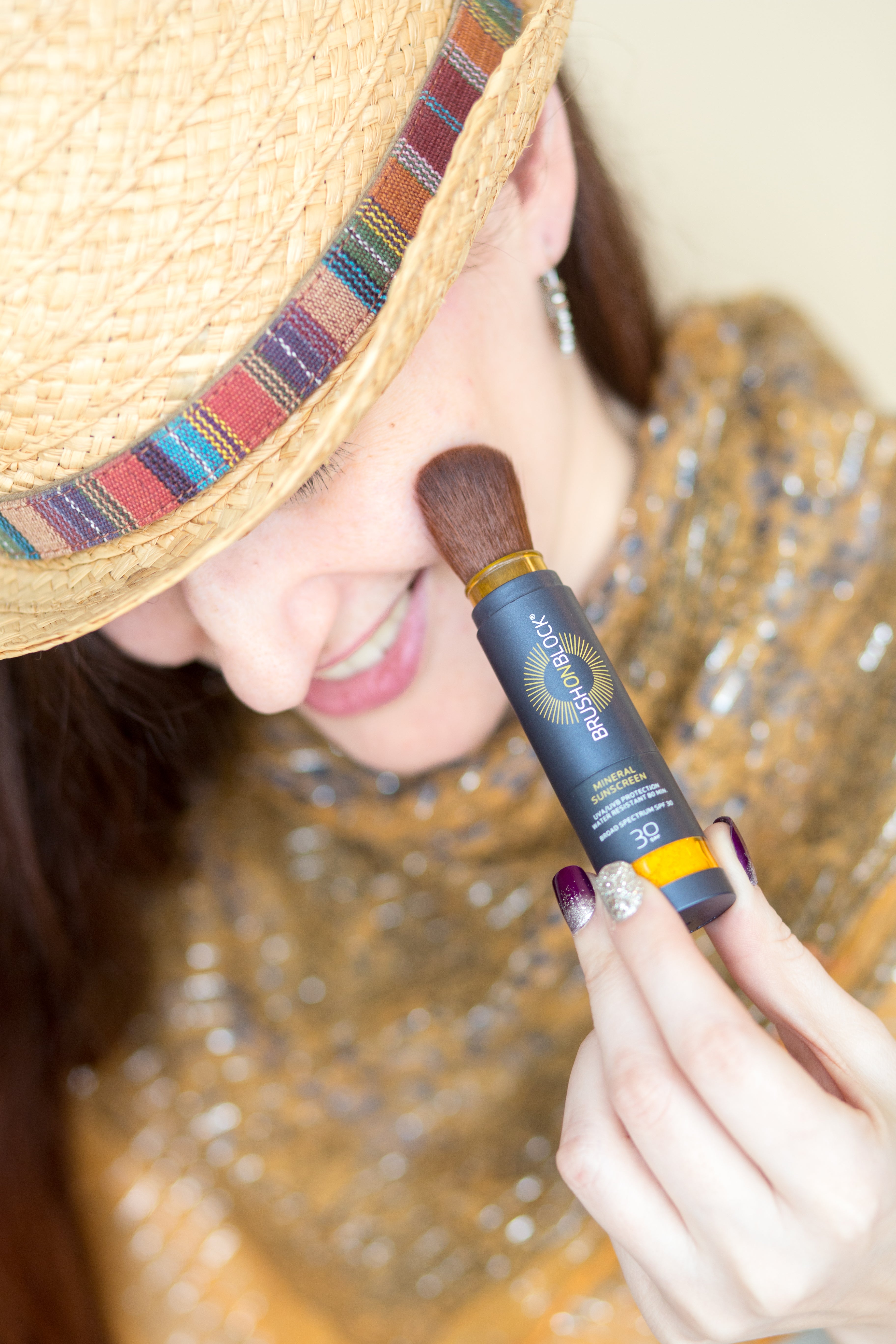 Woman in hat applying Brush On Block