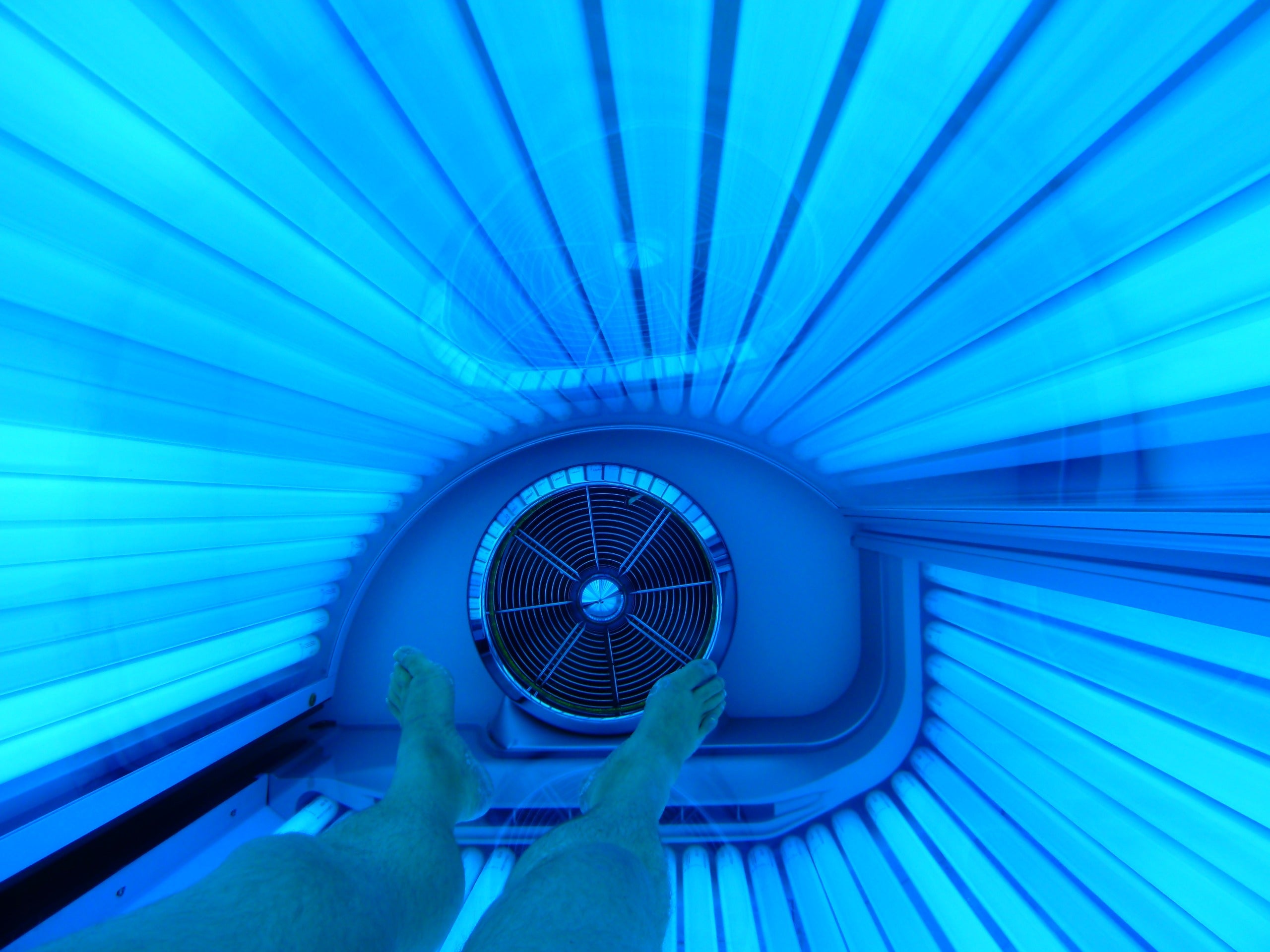 BRUSH ON BLOCK® image inside of tanning bed