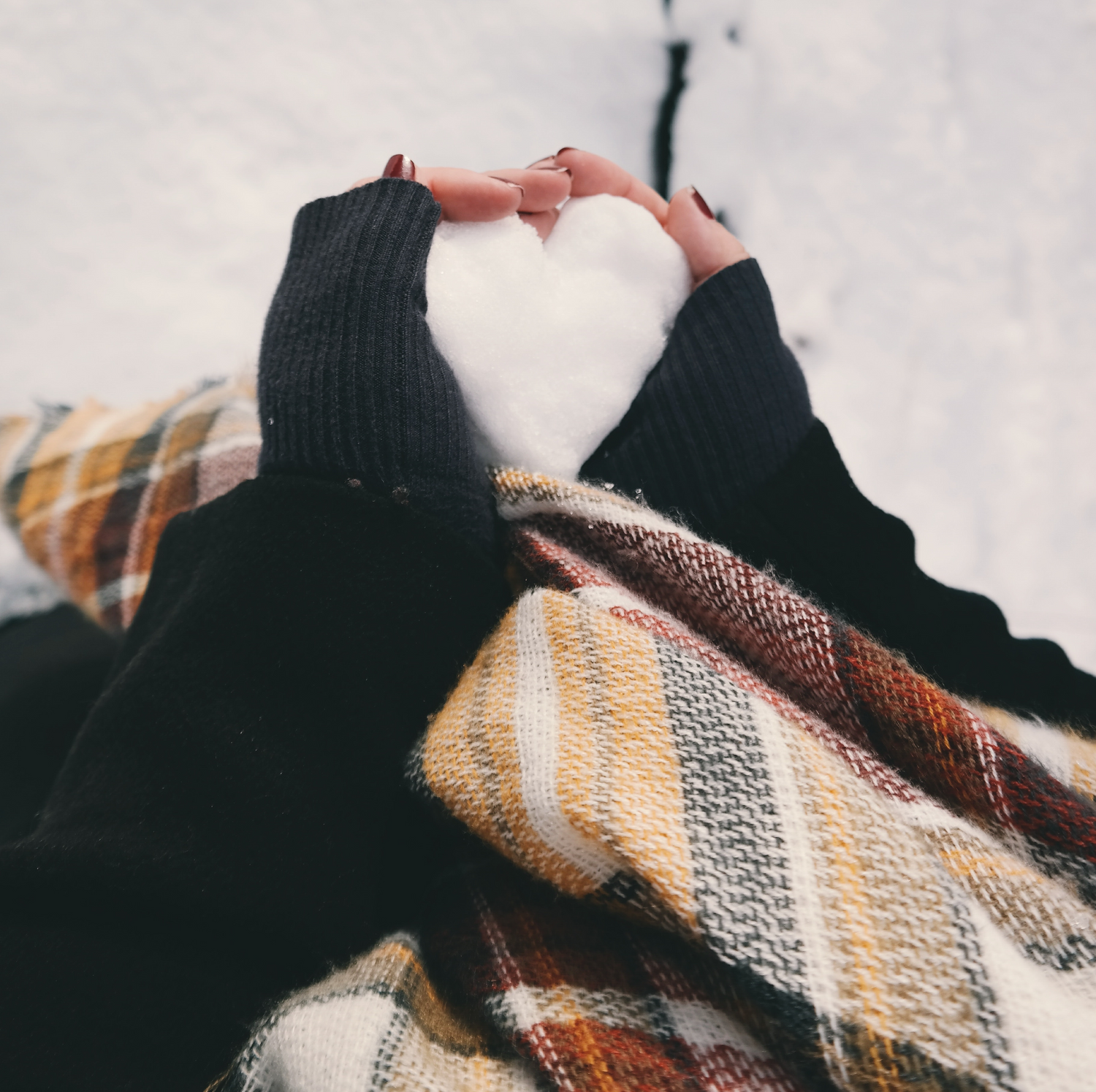 Brush On Block image of hands making a heart in snow.