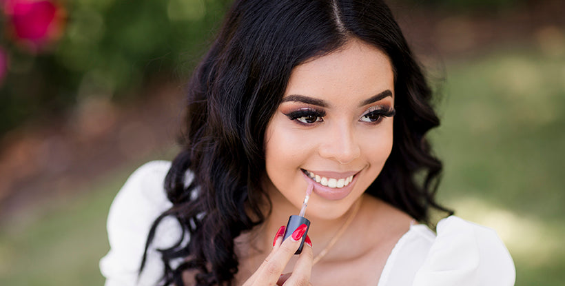 Image of woman applying BRUSH ON BLOCK® Protective Lip Oil.