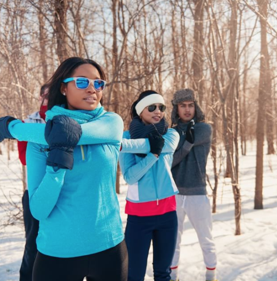 Brush On Block image of group of adults in winter clothes in the sun