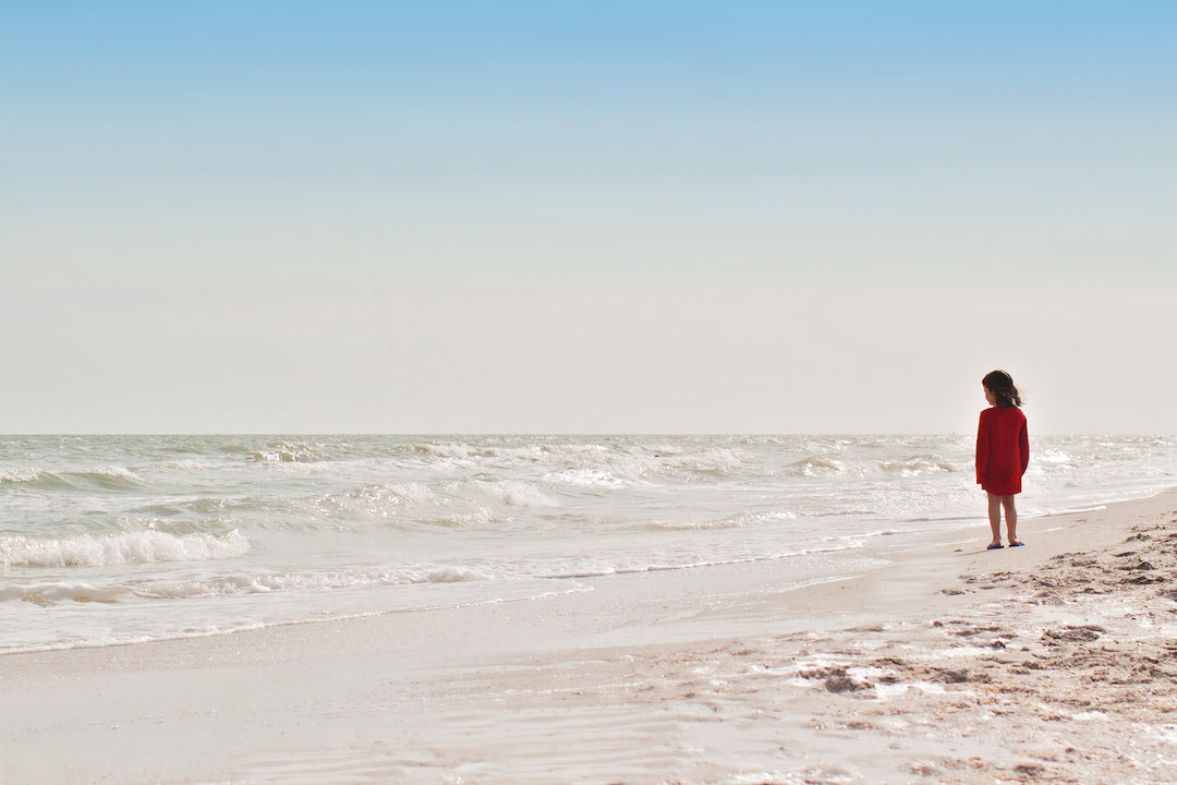 BRUSH ON BLOCK® image of young girl standing on beach.
