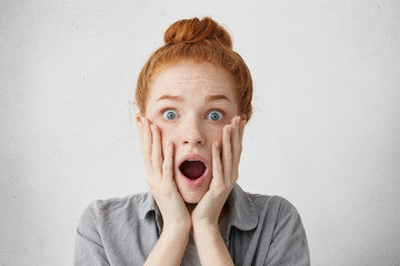 Brush On Block image of surprised woman with hands on face