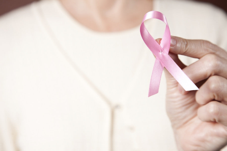 Brush On Block image of woman's had holding BCA pink ribbon