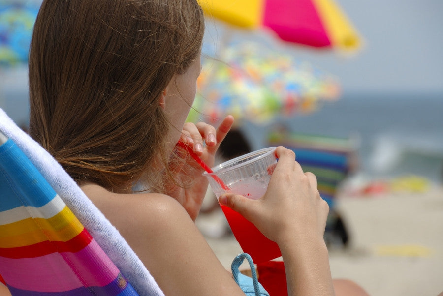Brush On Block image of woman at beach drinking adult beverage