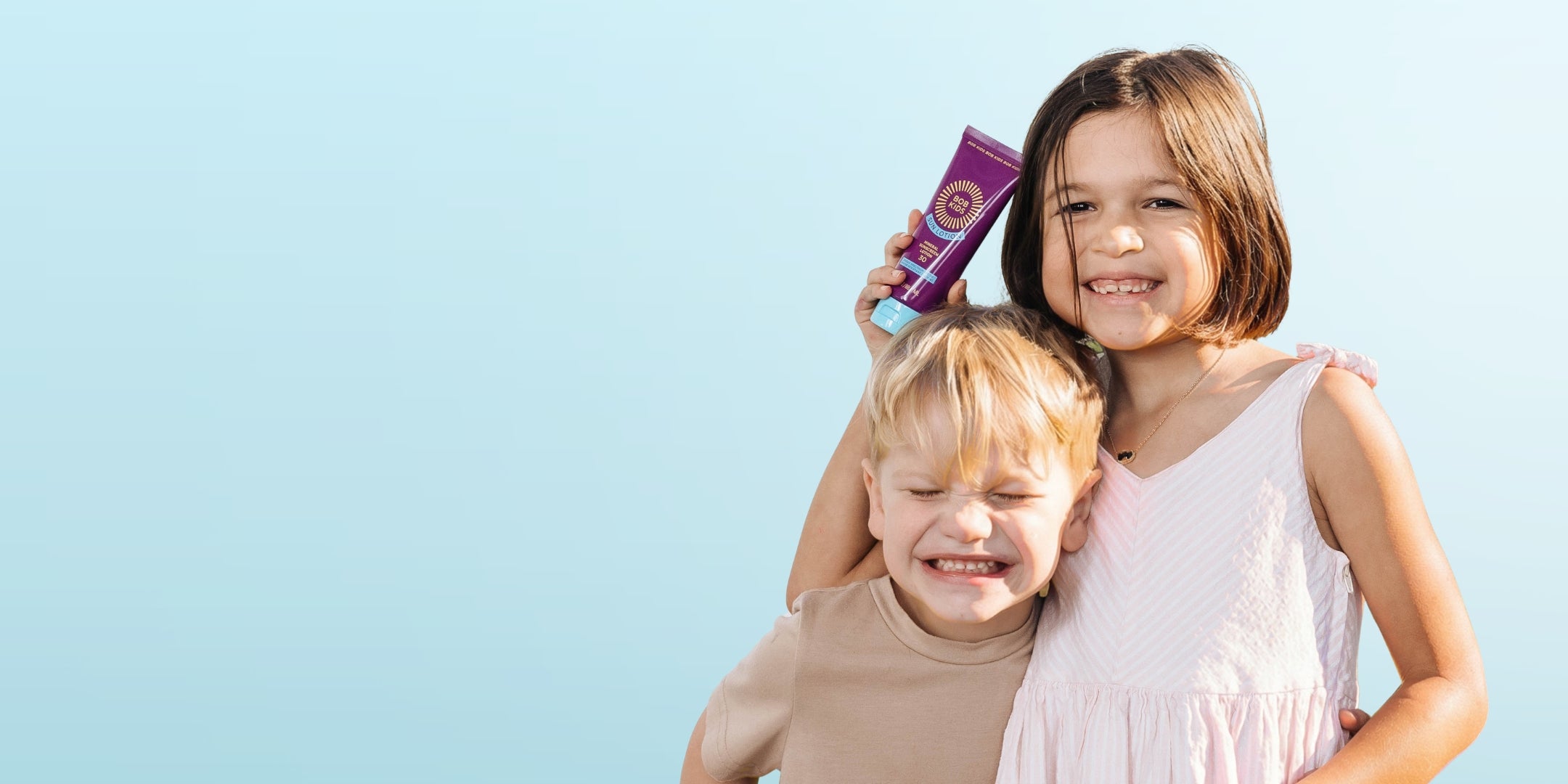 Two kids holding BOB KIDS SPF 30 Sun Lotion