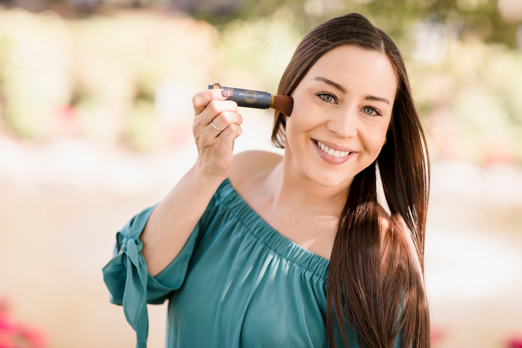 Woman Applying Brush On Block® Brush on Mineral Powder Sunscreen